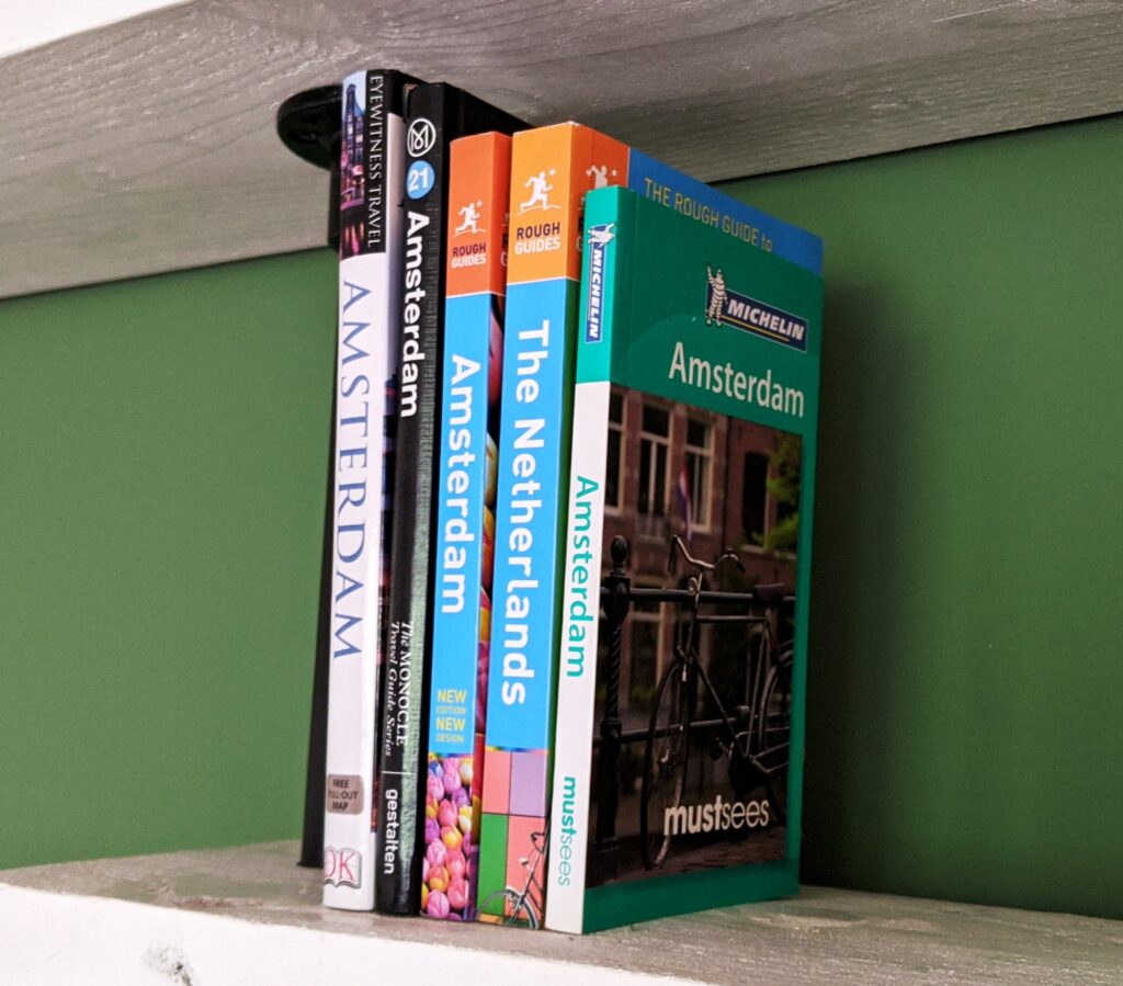 Guidebooks to Amsterdam and the Netherlands on a shelf